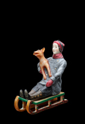 Miniature the boy on a sledge